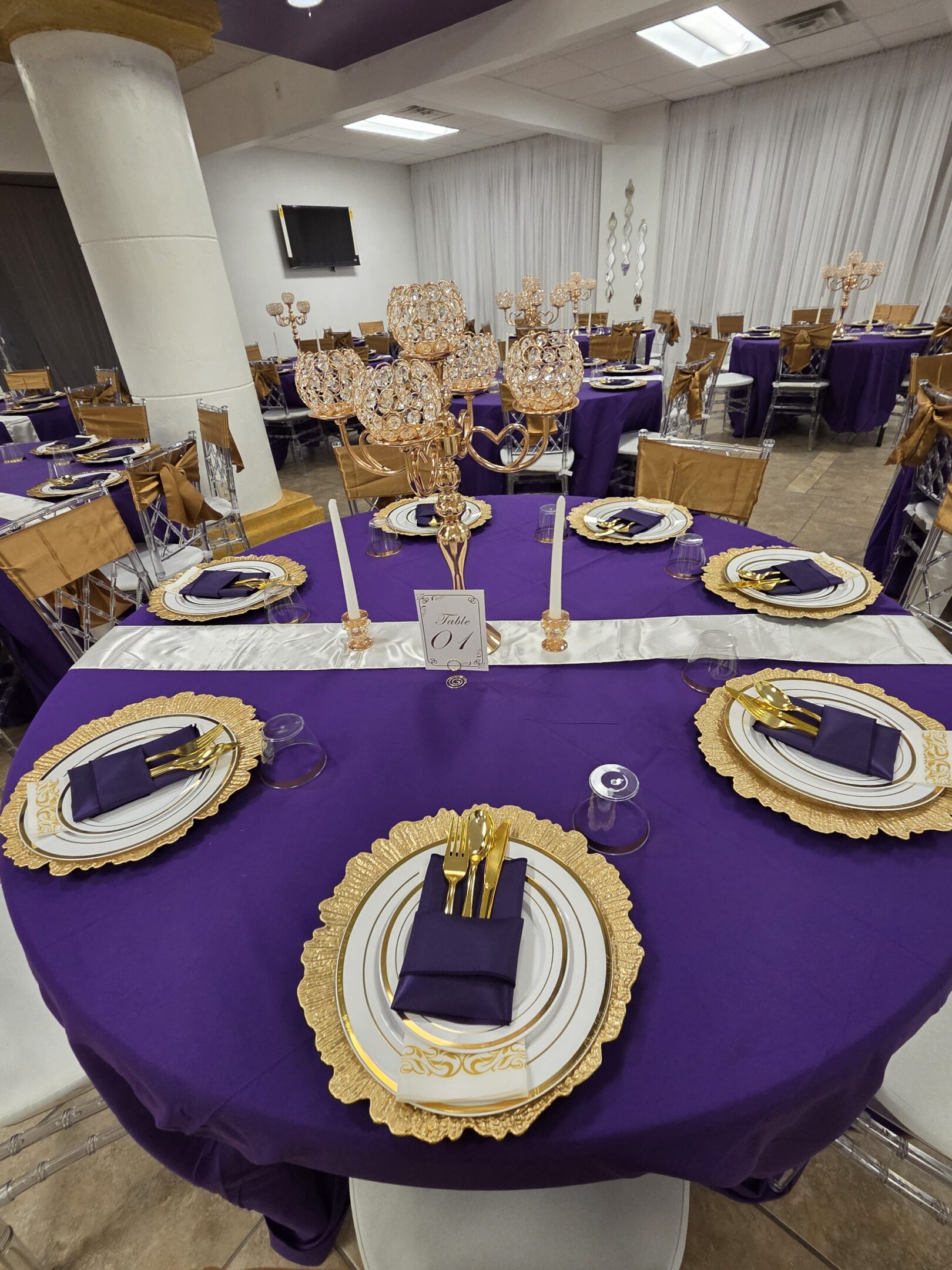 Elegant banquet tables with purple and gold decor