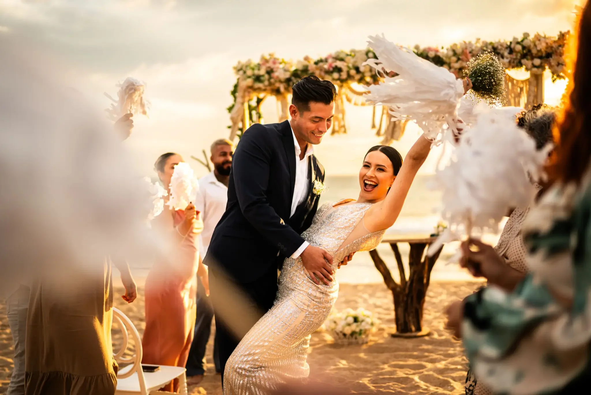 Bride and groom dancing at beach wedding